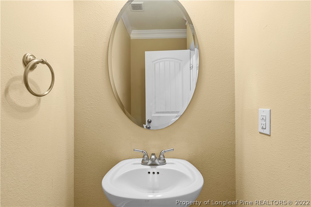 3479 Thrower Road Hope Mills, NC 28348 - Photo 19 of 41 a bathroom with a sink a mirror and a vanity