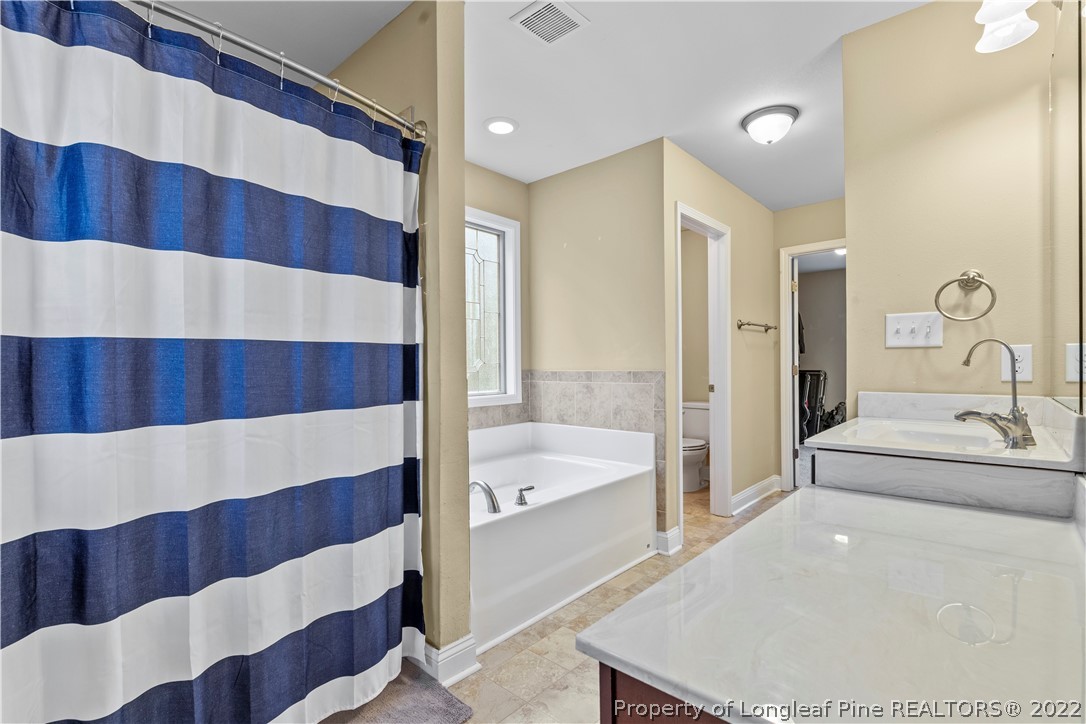 3479 Thrower Road Hope Mills, NC 28348 - Photo 26 of 41 a bathroom with a bathtub and a shower