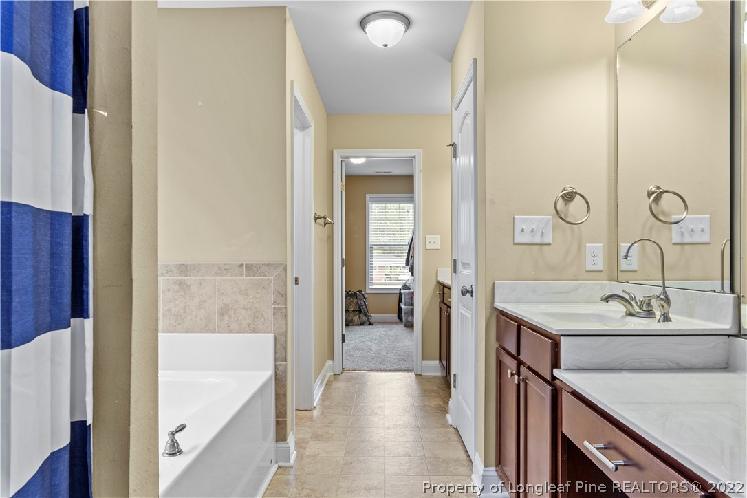 3479 Thrower Road Hope Mills, NC 28348 - Photo 27 of 41 a bathroom with a tub sink and mirror