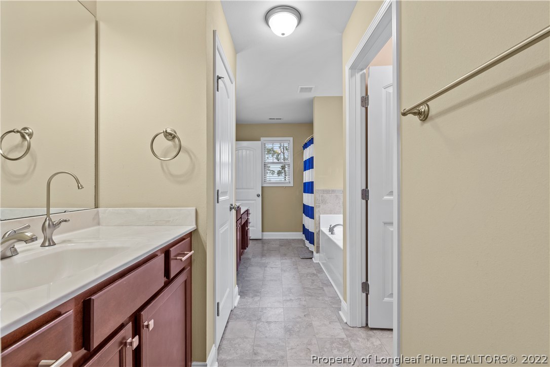 3479 Thrower Road Hope Mills, NC 28348 - Photo 29 of 41 a en suite bathroom with a sink and a mirror