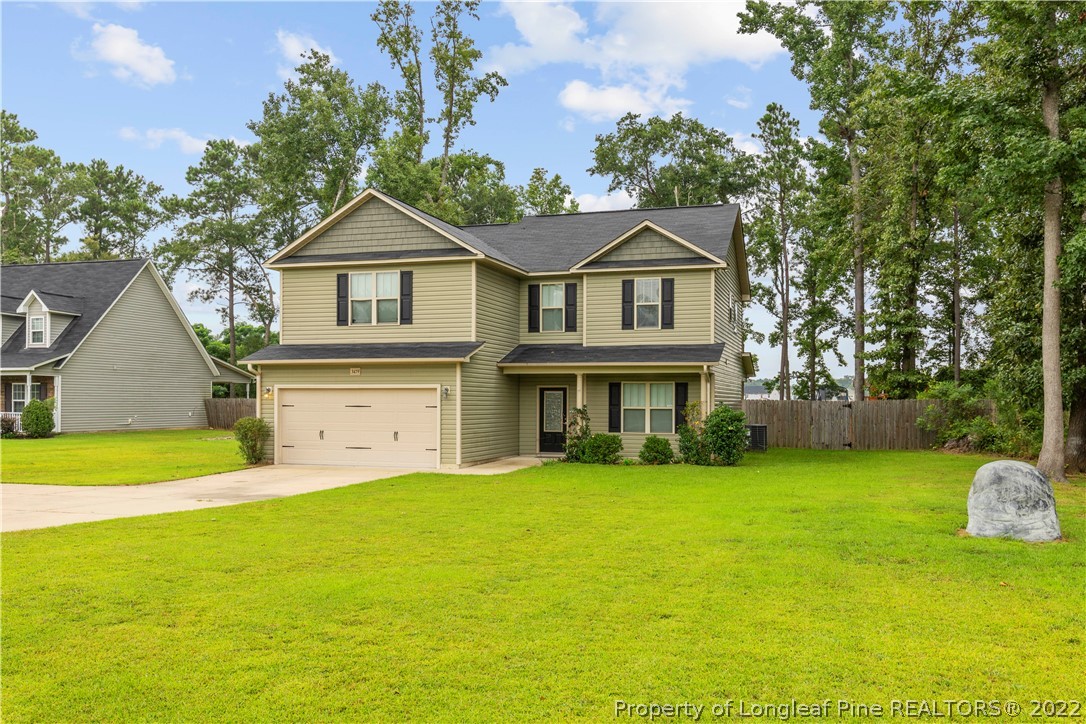 3479 Thrower Road Hope Mills, NC 28348 - Photo 3 of 41 a front view of a house with a garden and yard