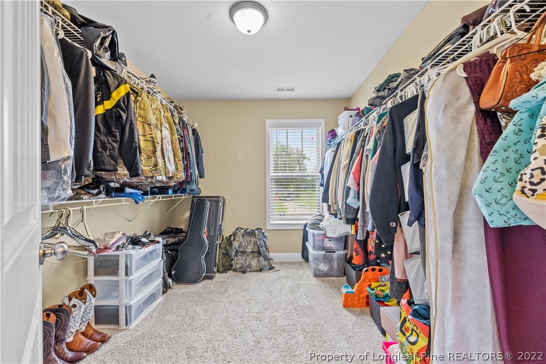 3479 Thrower Road Hope Mills, NC 28348 - Photo 31 of 41 a view of walk in closet with clothes and shoes