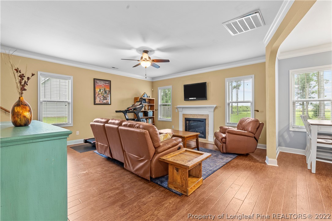 3479 Thrower Road Hope Mills, NC 28348 - Photo 8 of 41 a living room with furniture a fireplace and a flat screen tv