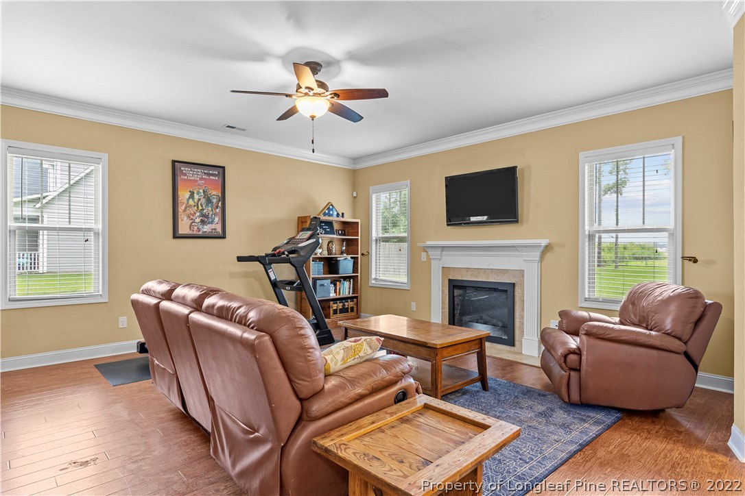 3479 Thrower Road Hope Mills, NC 28348 - Photo 9 of 41 a living room with furniture a flat screen tv and a fireplace