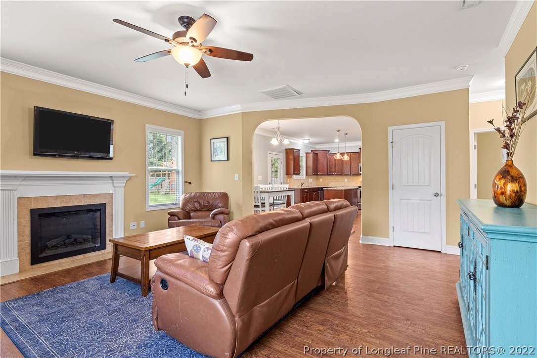 3479 Thrower Road Hope Mills, NC 28348 - Photo 10 of 41 a living room with furniture a fireplace and a flat screen tv