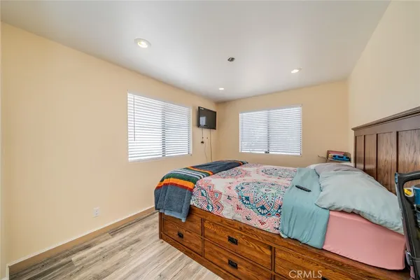 a bedroom with a bed and a flat screen tv