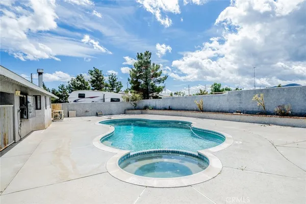 a view of swimming pool with seating space