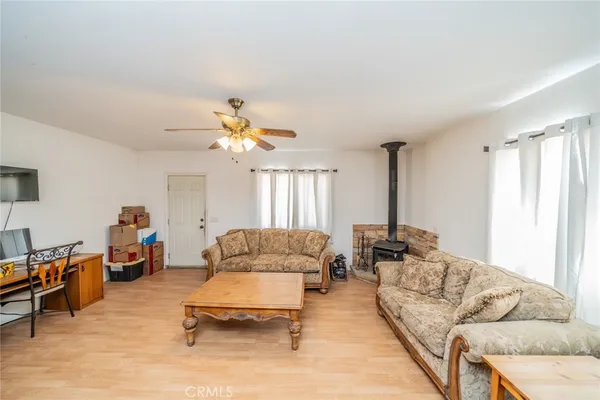a living room with furniture and kitchen view