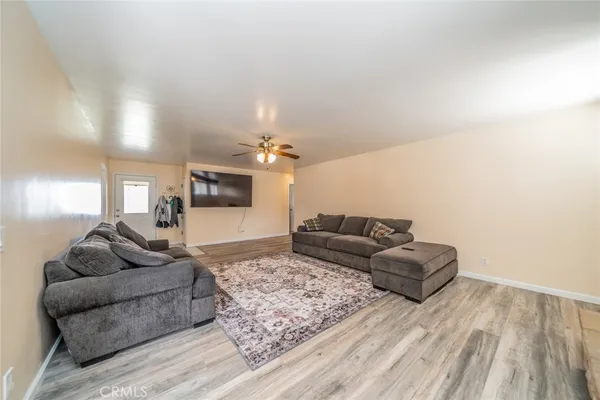a living room with furniture and a wooden floor