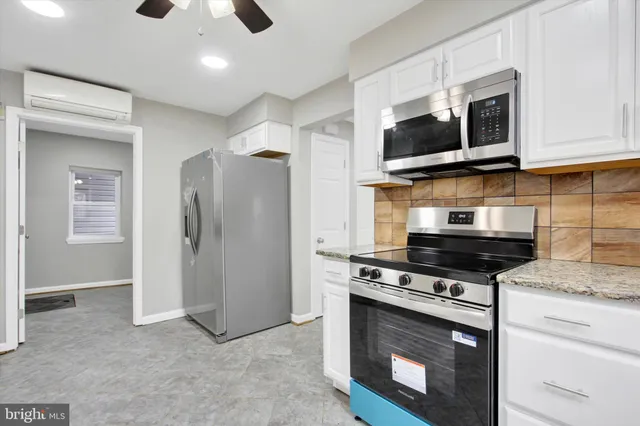 a kitchen with stainless steel appliances granite countertop a stove microwave and refrigerator