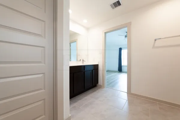 a view of hallway with bathroom
