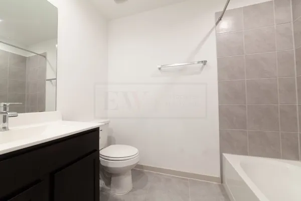 a bathroom with a sink a toilet a shower and a mirror