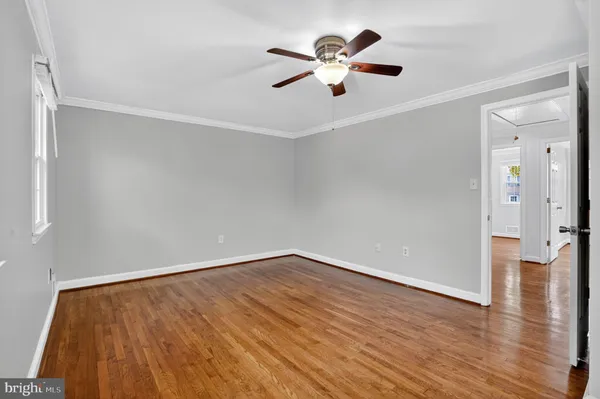 a view of a room with wooden floor and windows