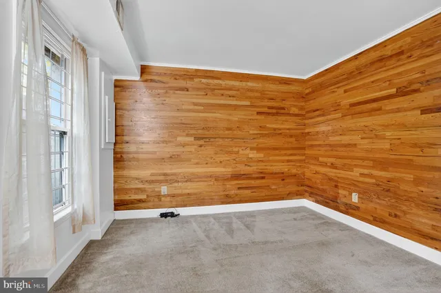a view of empty room with floor to ceiling window