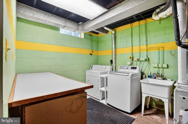 a view of a house with a yard and wooden fence