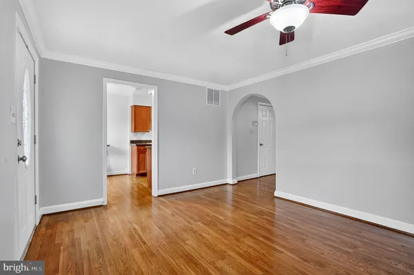 a kitchen with granite countertop a sink a stove top oven a refrigerator cabinets and a counter top space