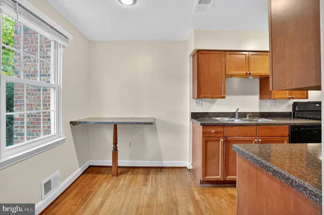 a view of a kitchen with wooden floor and staircase