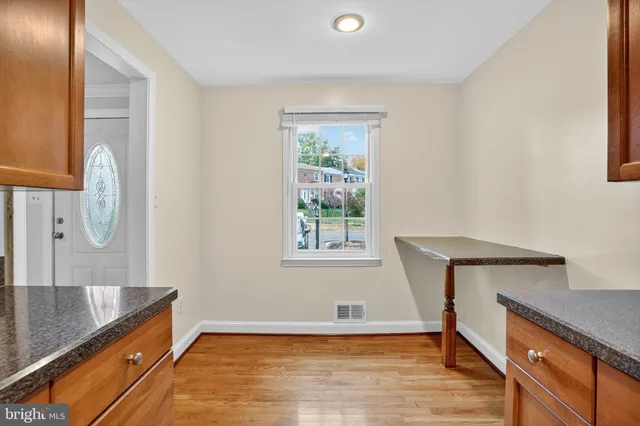 a view of a kitchen with wooden floor and cabinet