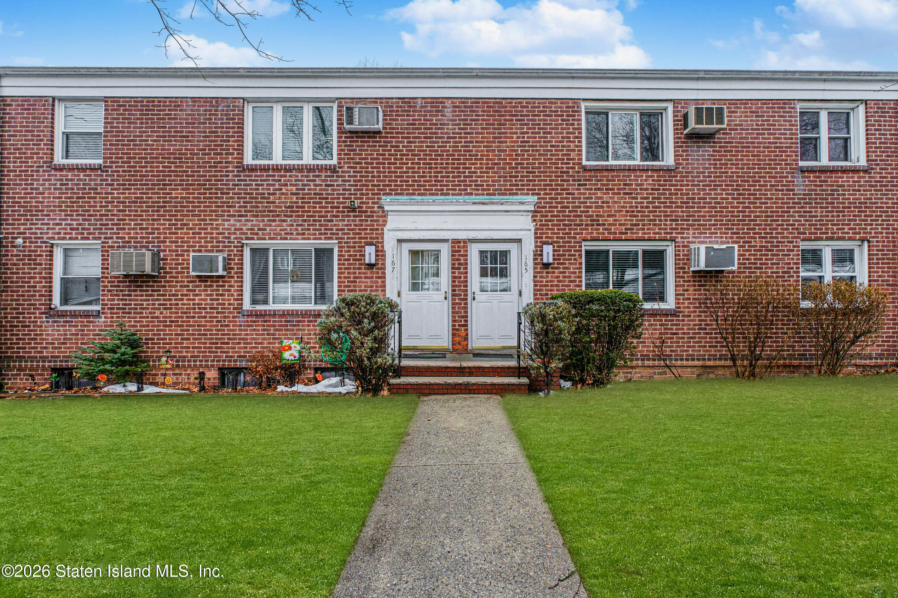 a front view of a house with a garden