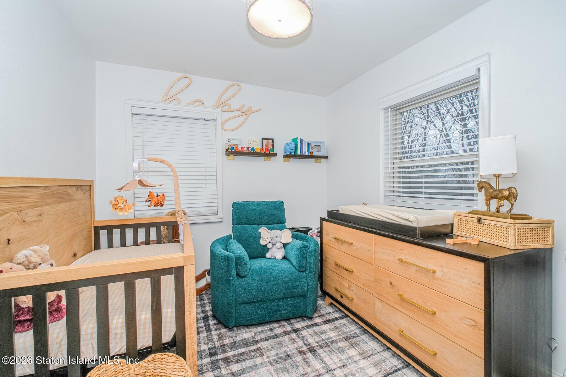 167 Arlo Road, Unit B Staten Island, NY 10301 - Photo 11 of 12 a bedroom with furniture and a window