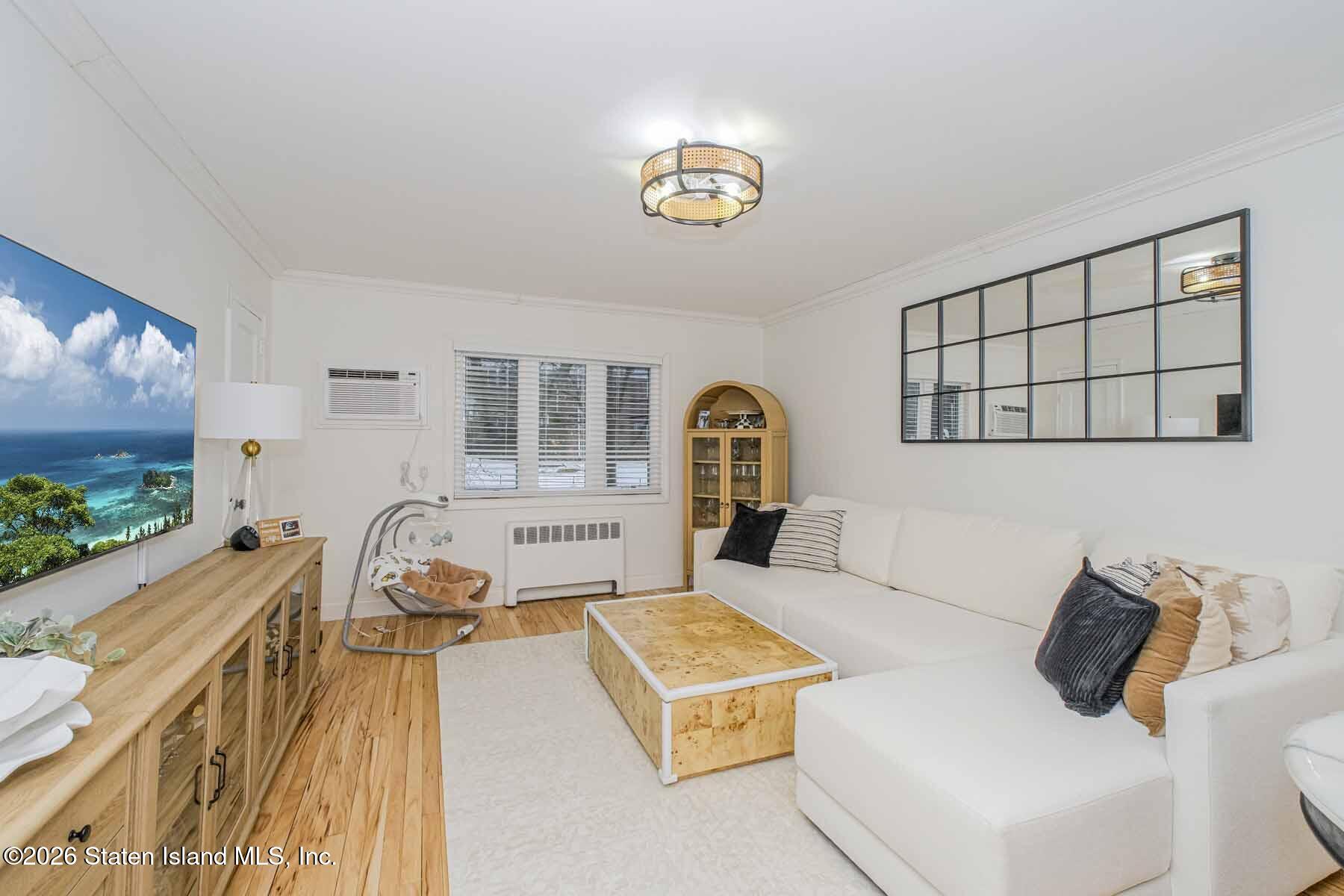 167 Arlo Road, Unit B Staten Island, NY 10301 - Photo 3 of 12 a living room with a couch and a flat screen tv