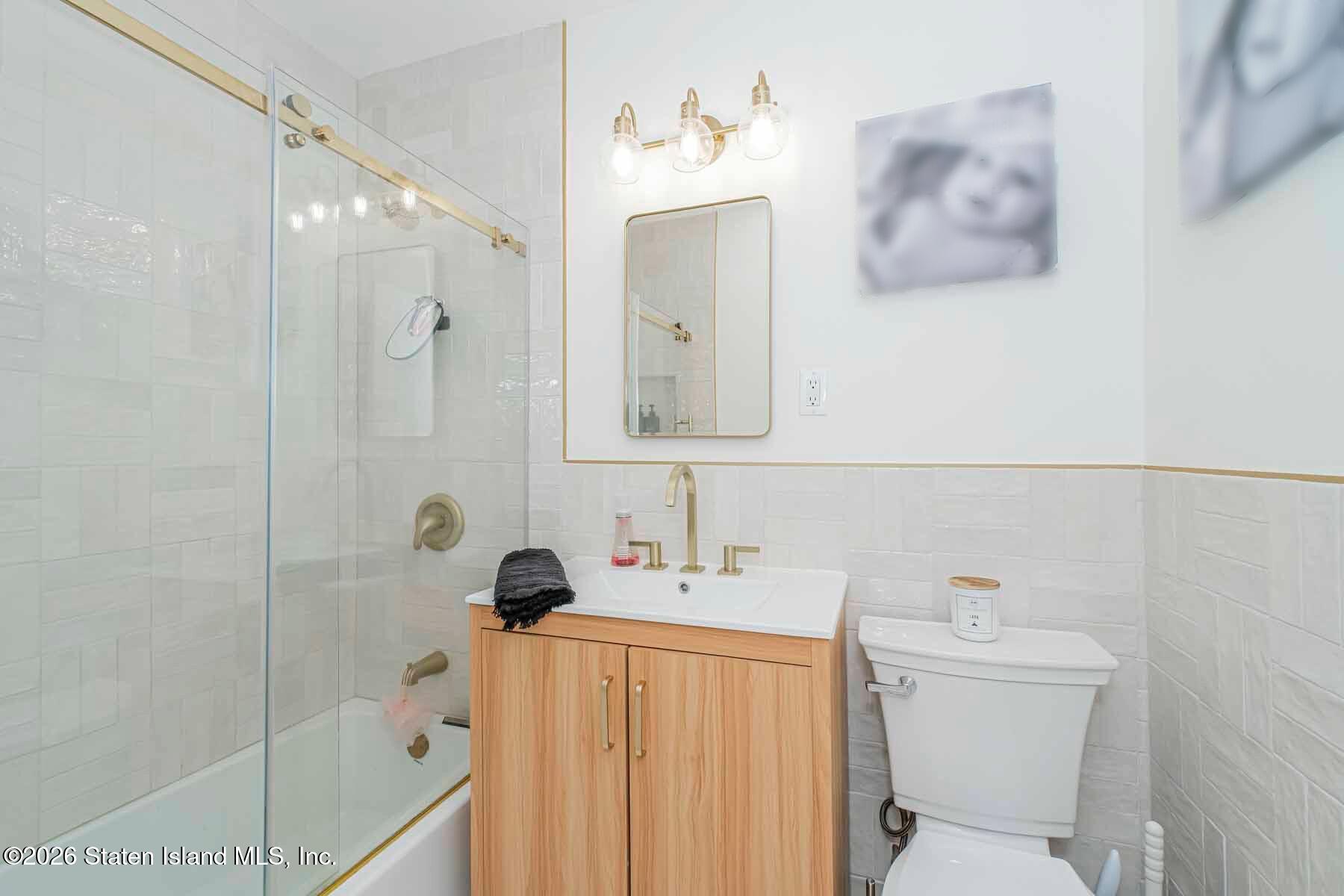 167 Arlo Road, Unit B Staten Island, NY 10301 - Photo 4 of 12 a bathroom with a sink a toilet and shower