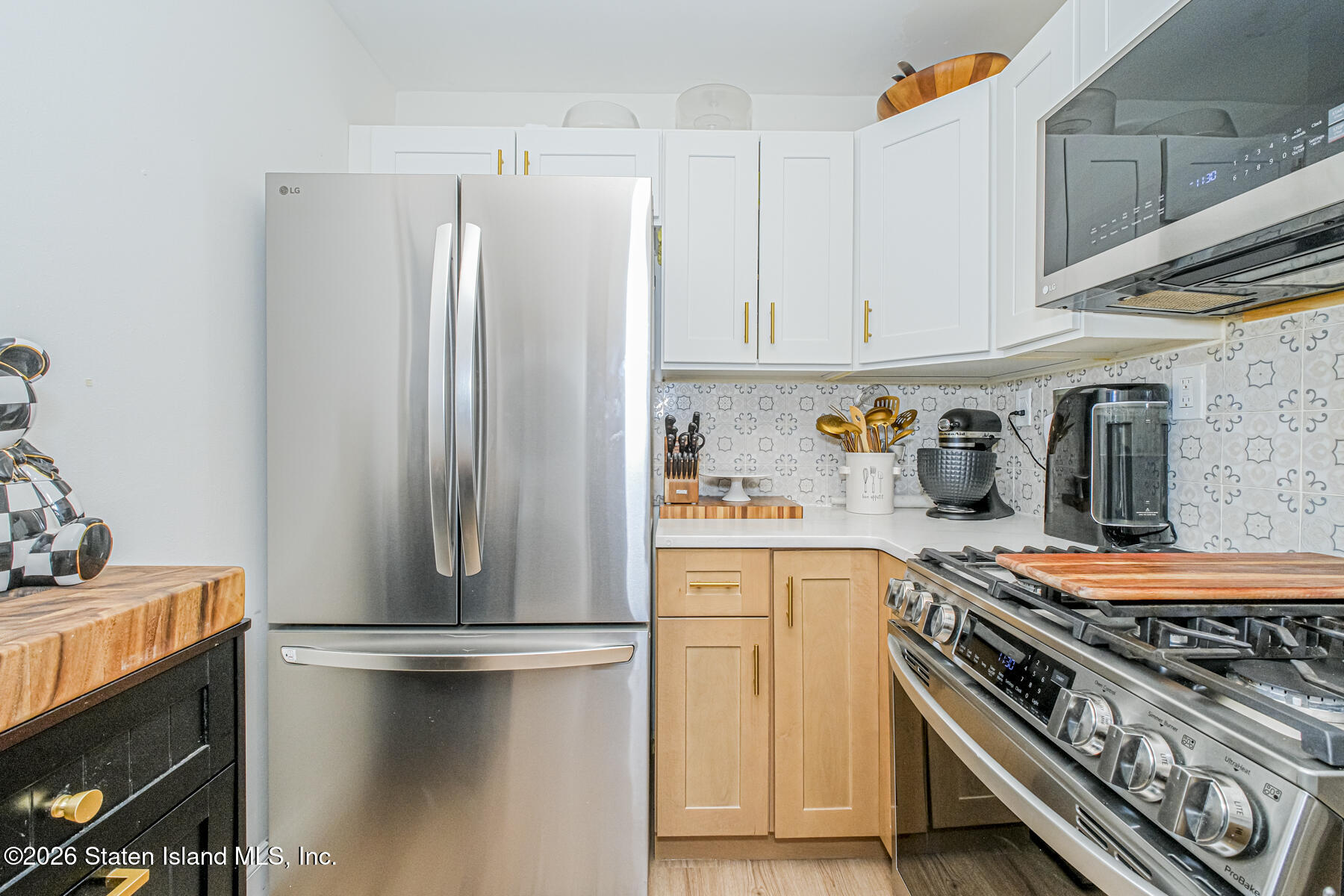 167 Arlo Road, Unit B Staten Island, NY 10301 - Photo 5 of 12 a kitchen with stainless steel appliances granite countertop a refrigerator and a stove