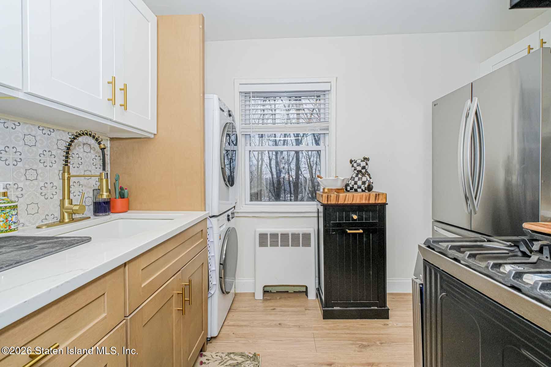 167 Arlo Road, Unit B Staten Island, NY 10301 - Photo 6 of 12 a kitchen with a sink stove and refrigerator