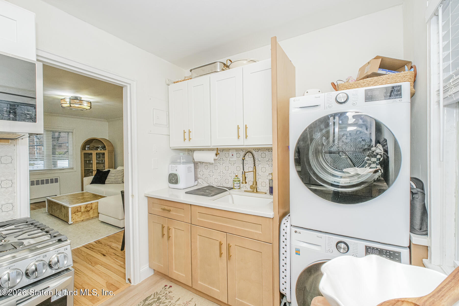 167 Arlo Road, Unit B Staten Island, NY 10301 - Photo 8 of 12 a bathroom with a sink a washer and dryer