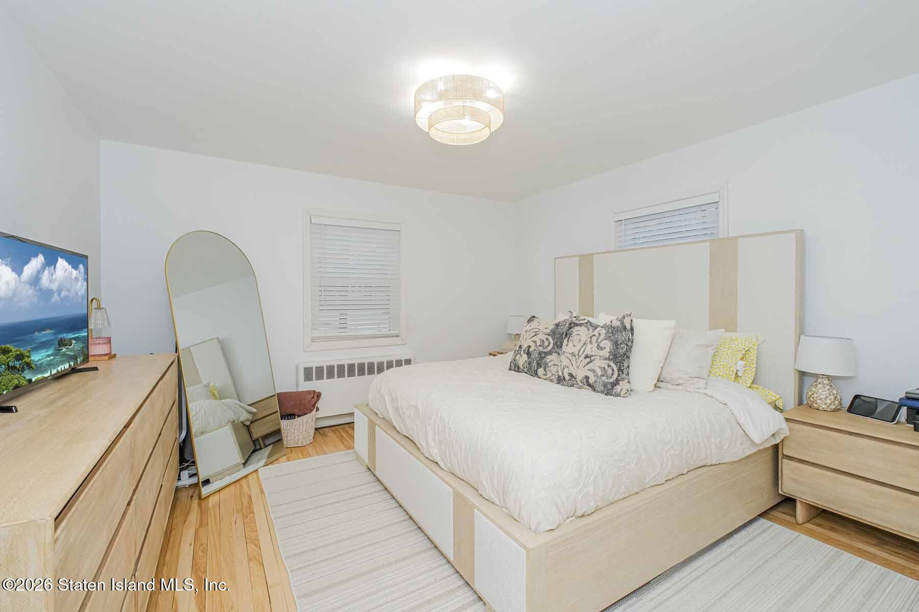 167 Arlo Road, Unit B Staten Island, NY 10301 - Photo 9 of 12 a bedroom with a bed and a flat screen tv
