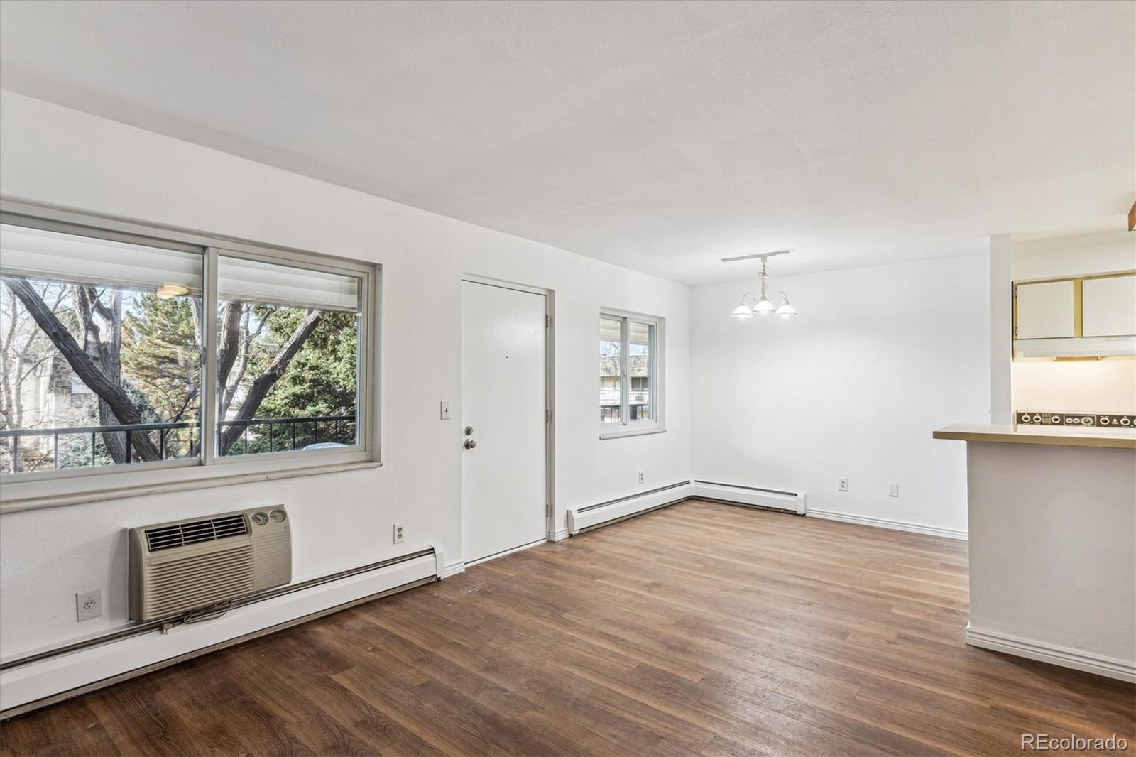 5770 East Warren Avenue, Unit 305 Denver, CO 80222 - Photo 1 of 24 wooden floor in an empty room with a window