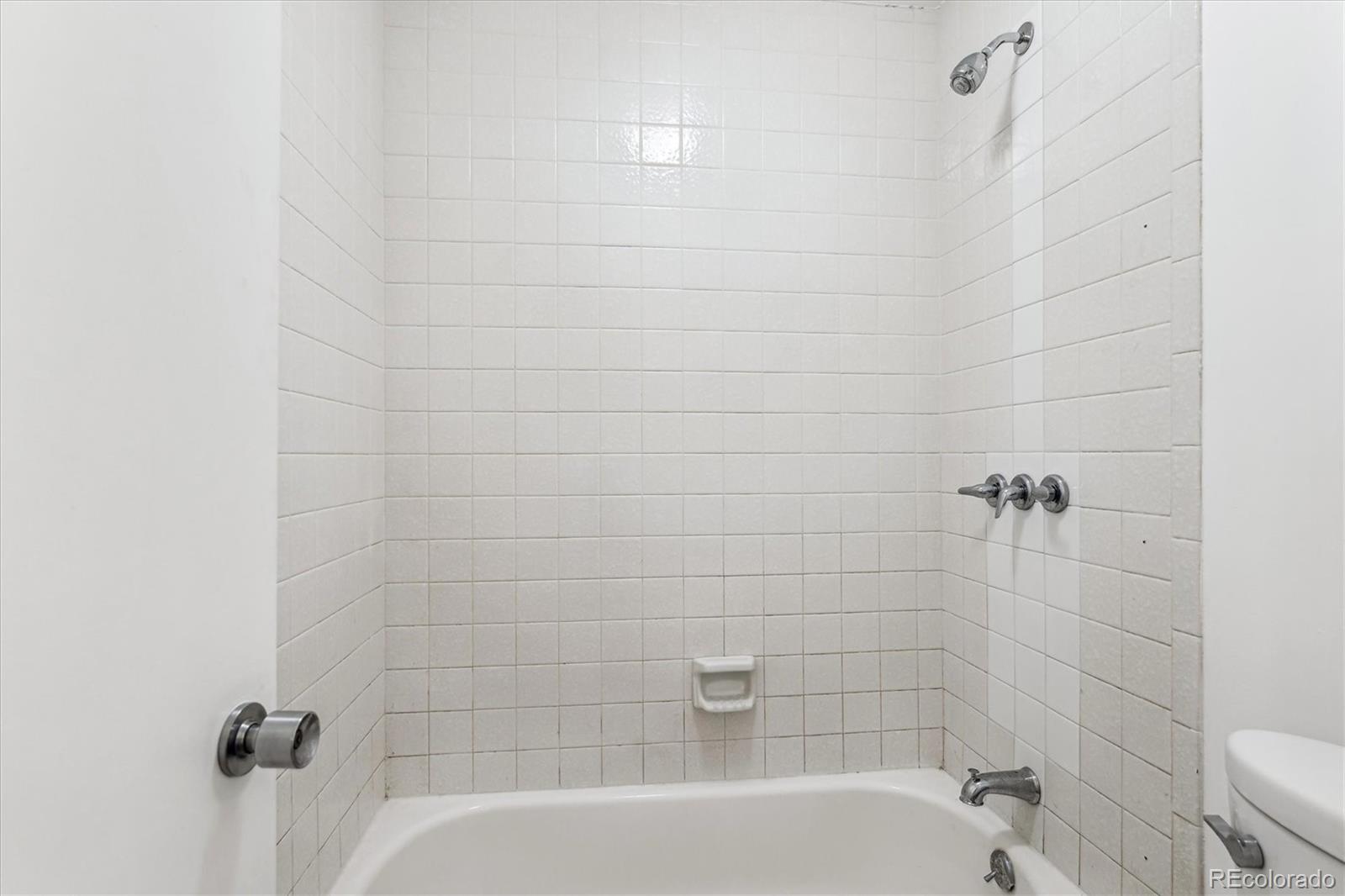 5770 East Warren Avenue, Unit 305 Denver, CO 80222 - Photo 13 of 24 a bathroom with a bathtub