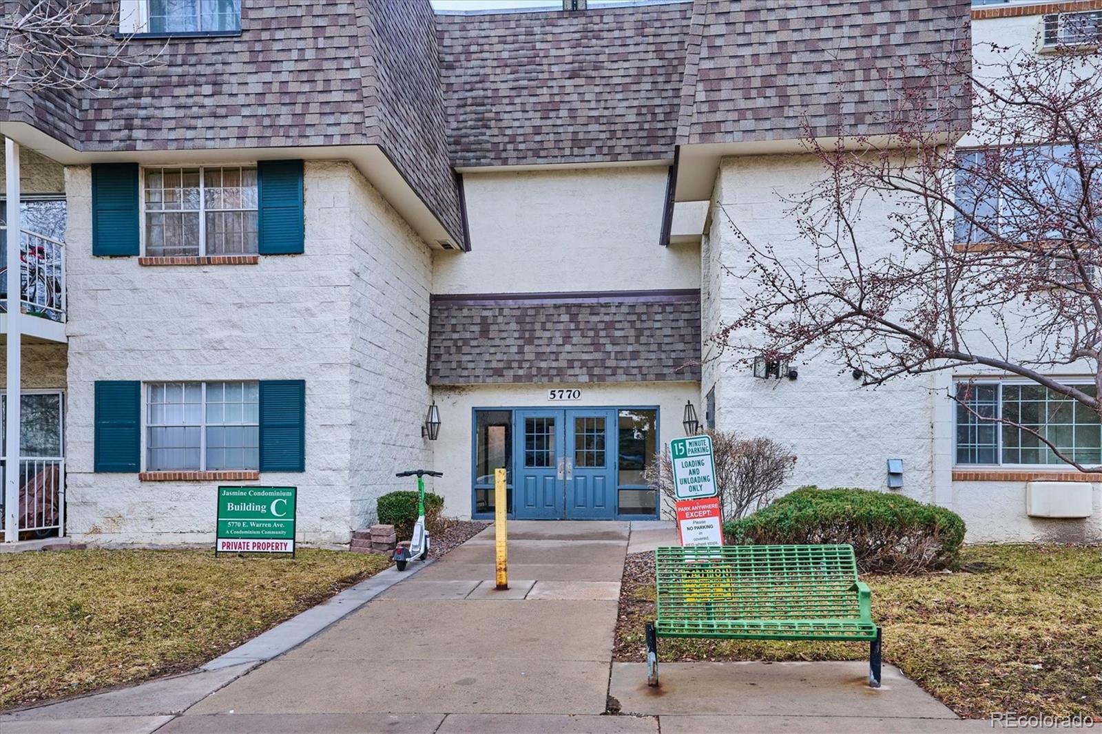 5770 East Warren Avenue, Unit 305 Denver, CO 80222 - Photo 17 of 24 a front view of a house with garden and plants