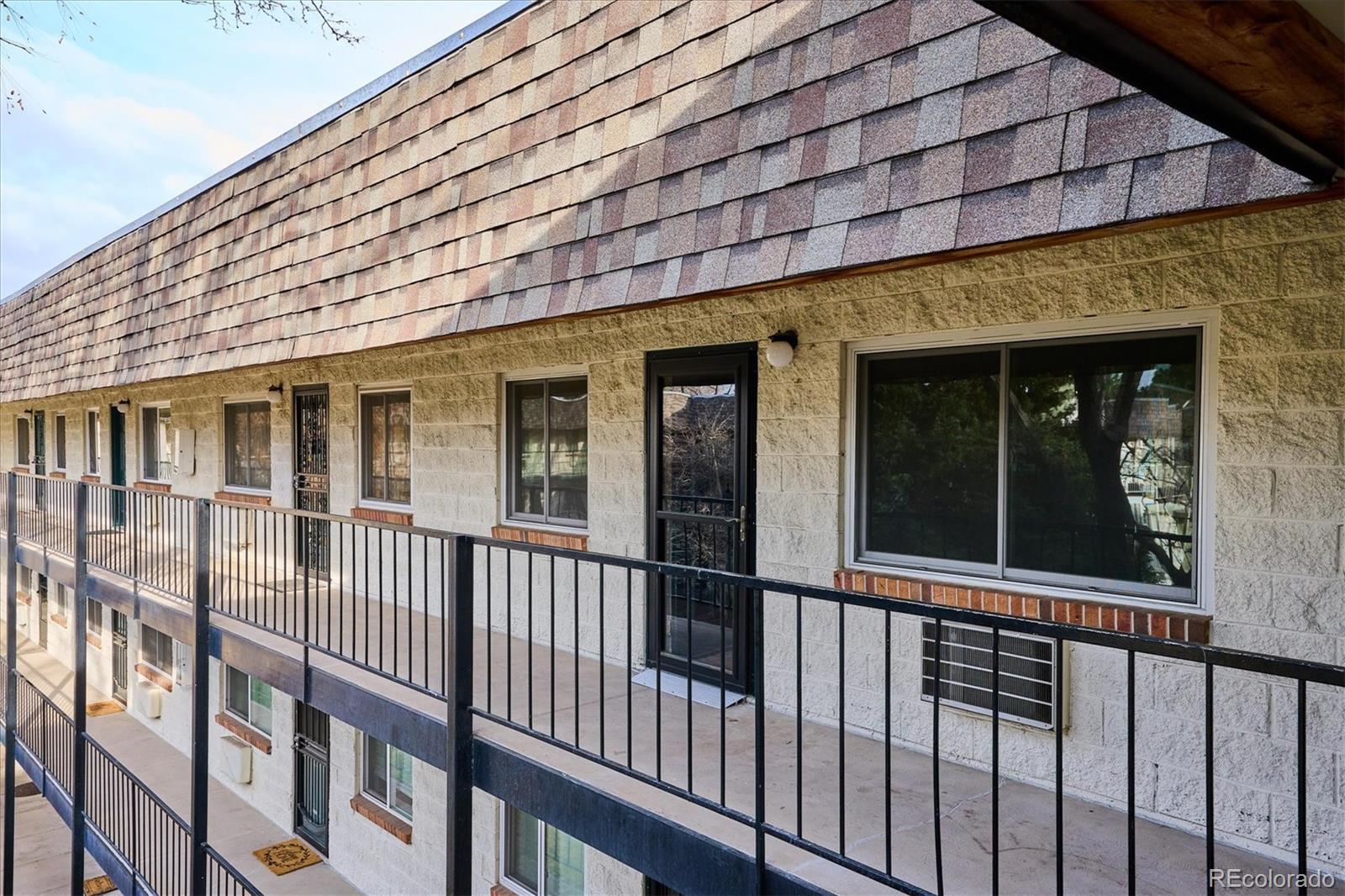 5770 East Warren Avenue, Unit 305 Denver, CO 80222 - Photo 2 of 24 a view of a large brick building