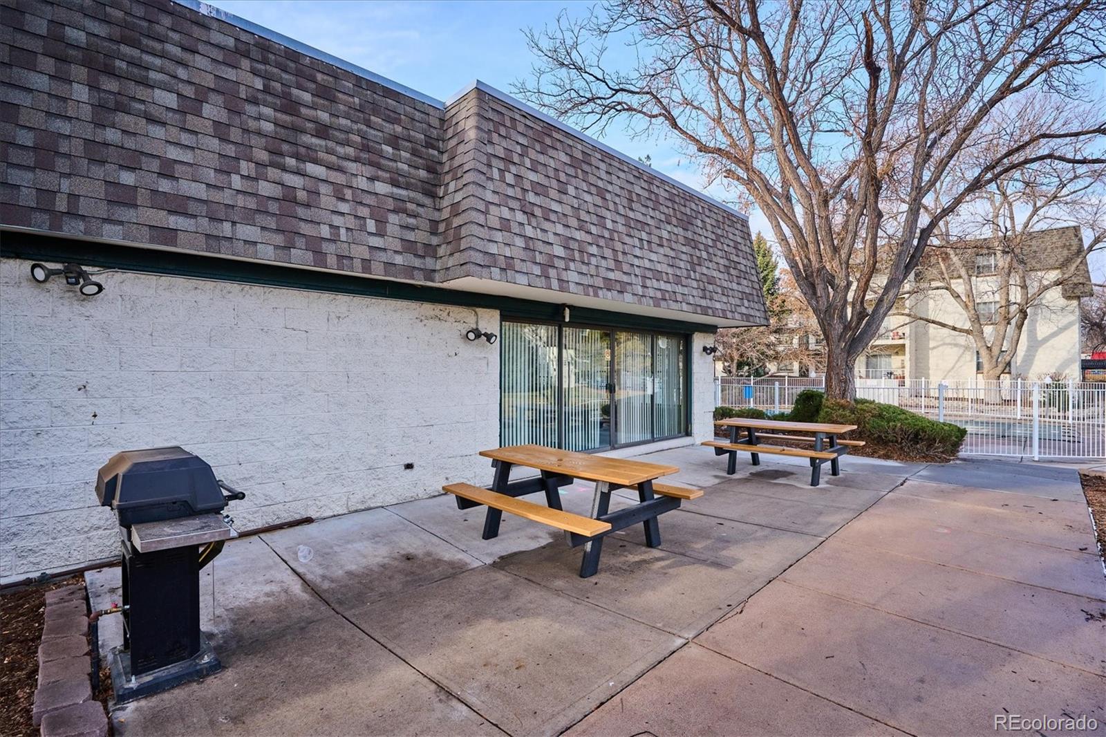 5770 East Warren Avenue, Unit 305 Denver, CO 80222 - Photo 21 of 24 a backyard of a house with outdoor seating