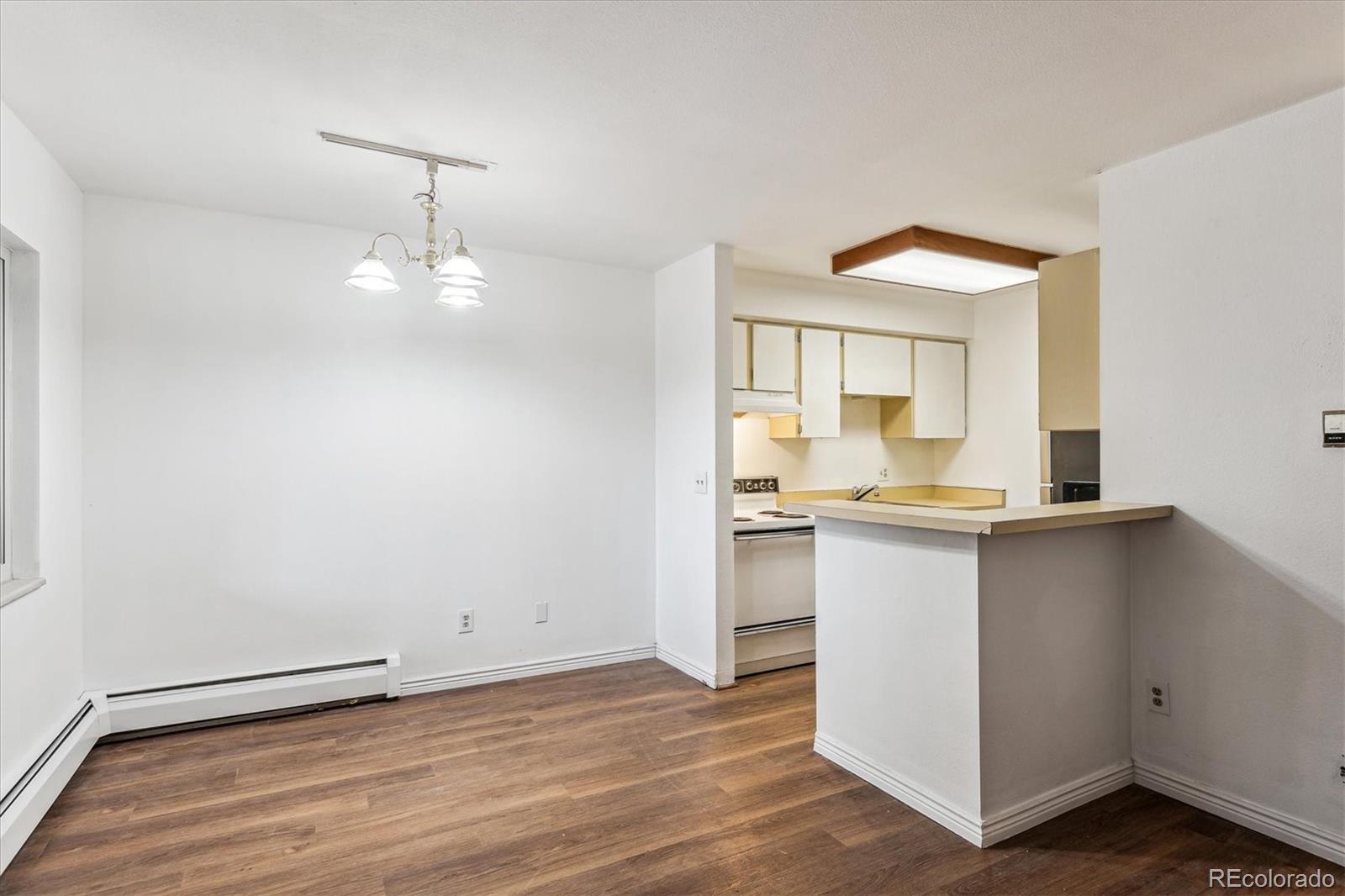 5770 East Warren Avenue, Unit 305 Denver, CO 80222 - Photo 3 of 24 a bathroom with a sink and a mirror