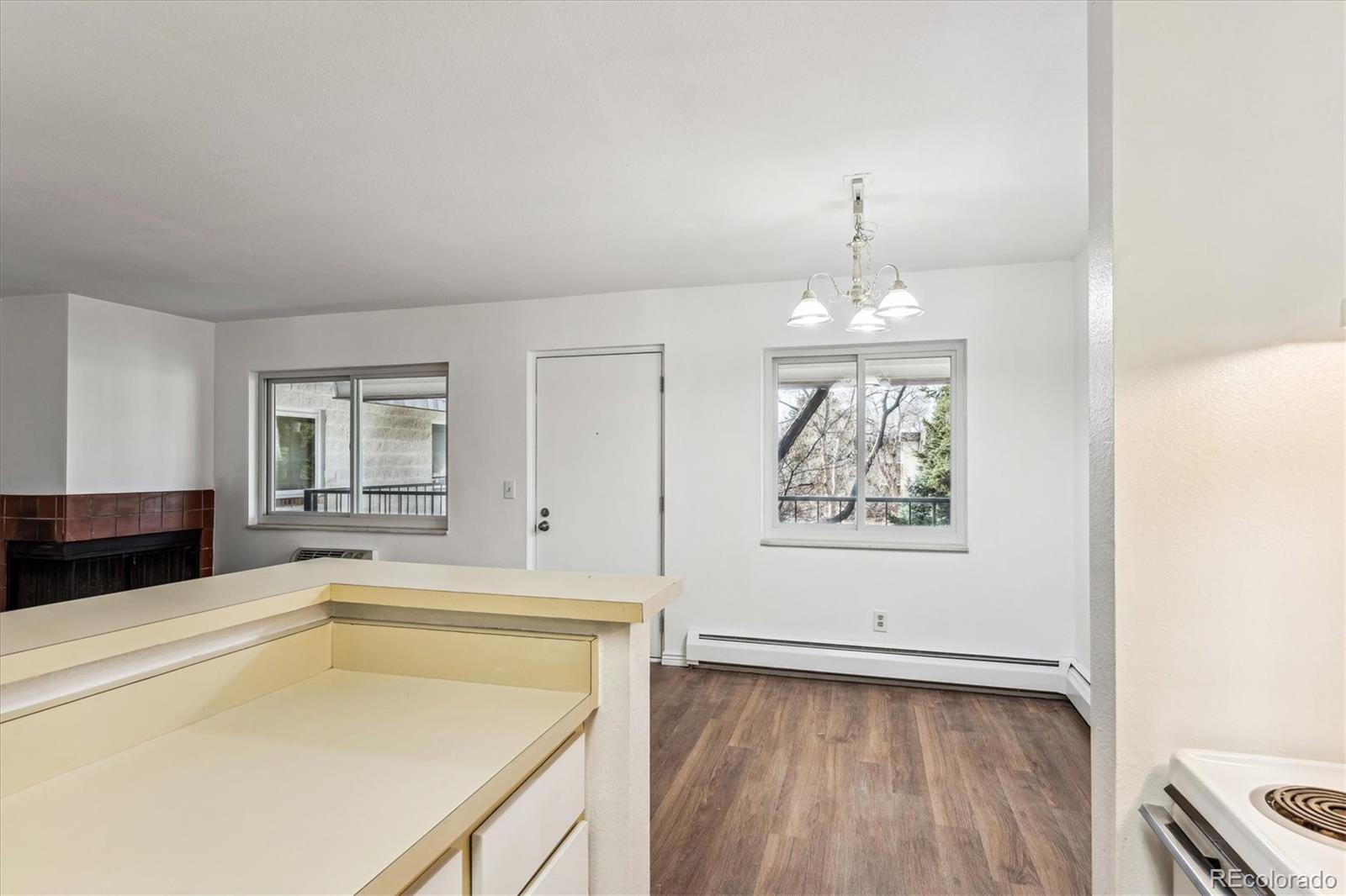 5770 East Warren Avenue, Unit 305 Denver, CO 80222 - Photo 7 of 24 a view of a kitchen with a sink dishwasher and wooden floor