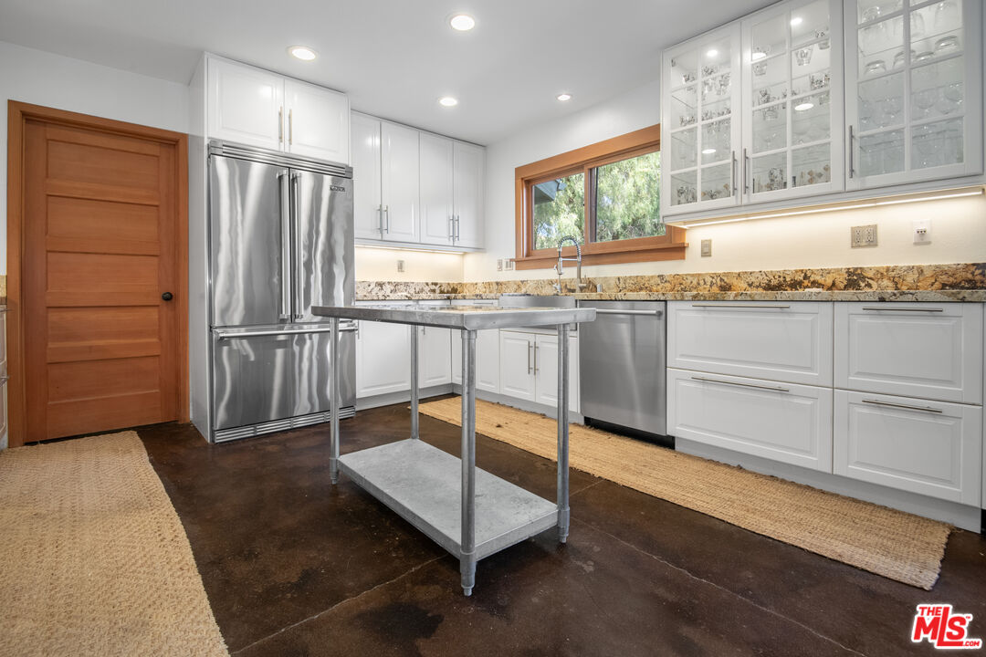 33208 Decker School Road Malibu, CA 90265 - Photo 12 of 51 a kitchen with stainless steel appliances granite countertop a stove a sink and a refrigerator