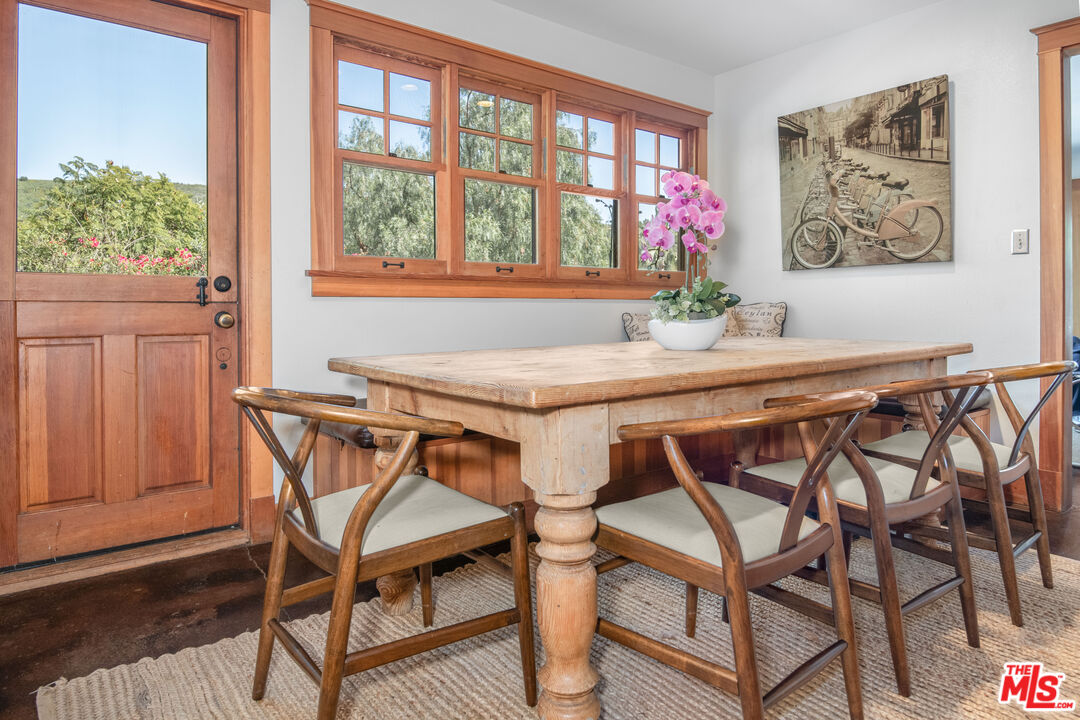 33208 Decker School Road Malibu, CA 90265 - Photo 13 of 51 a view of a dining room with furniture window and wooden floor