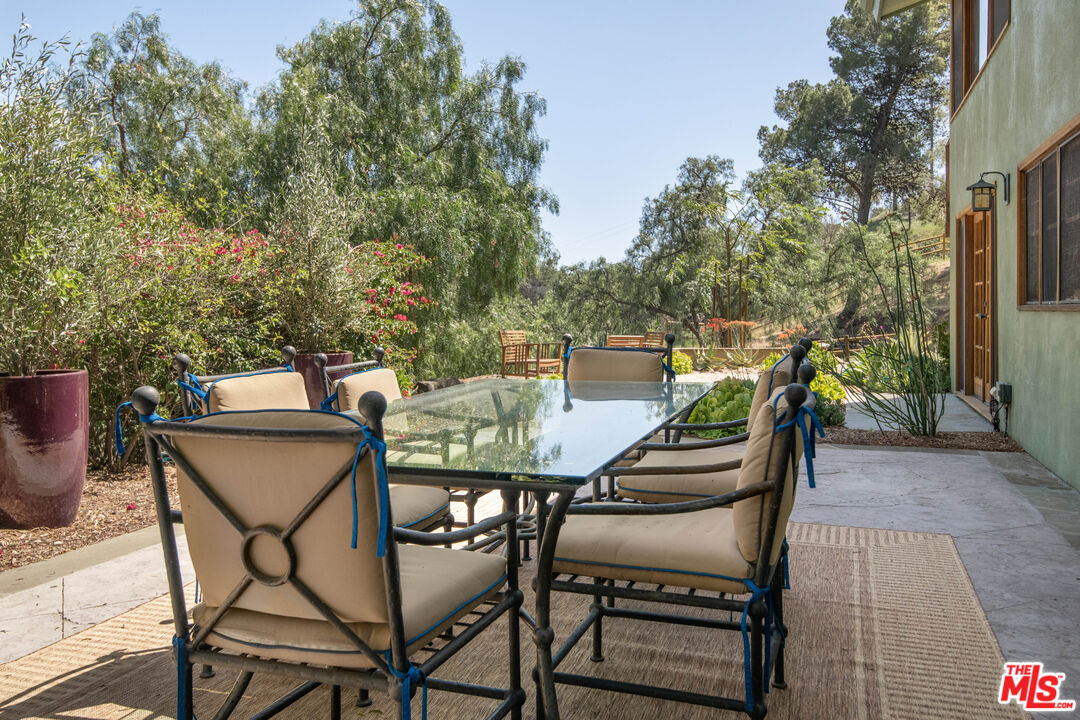 33208 Decker School Road Malibu, CA 90265 - Photo 14 of 51 a view of a patio with a table and chairs in patio