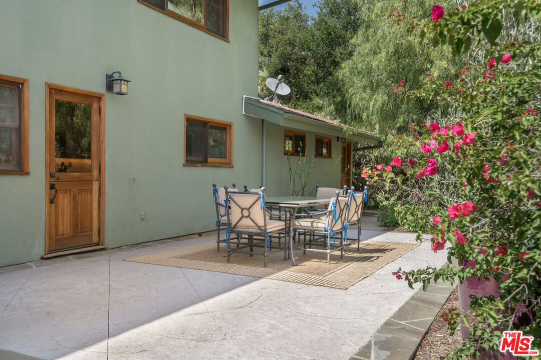33208 Decker School Road Malibu, CA 90265 - Photo 15 of 51 a view of a patio with table and chairs and potted plants