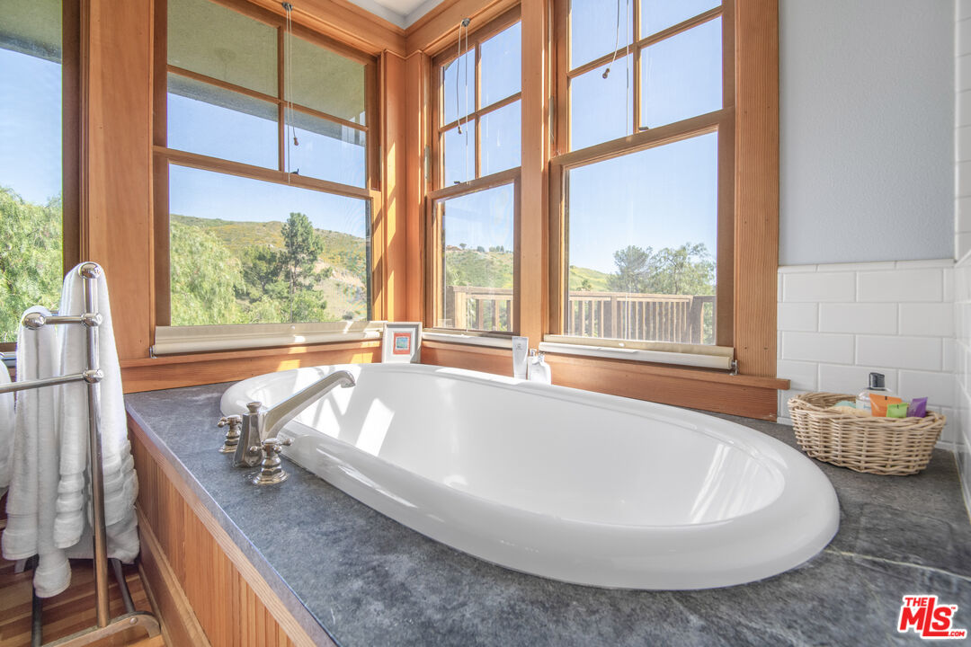 33208 Decker School Road Malibu, CA 90265 - Photo 23 of 51 a bath tub sitting in front of a window