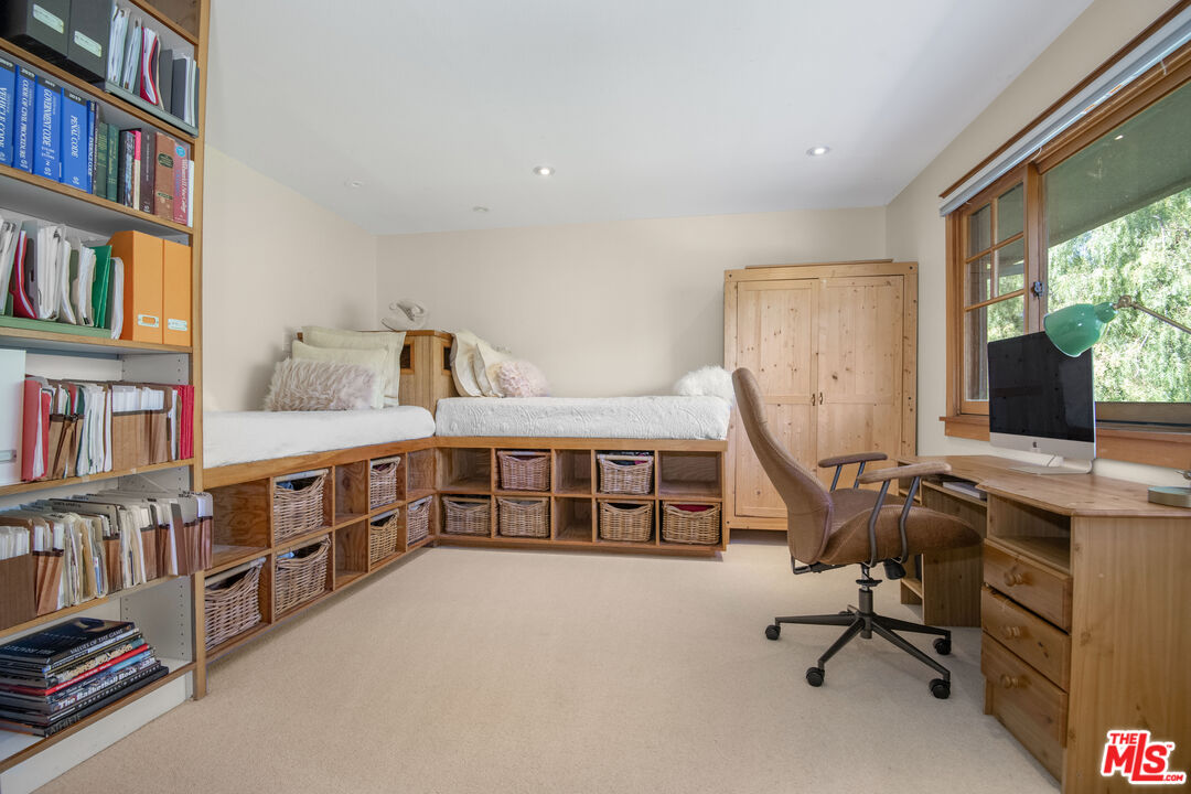 33208 Decker School Road Malibu, CA 90265 - Photo 28 of 51 a view of a workspace with furniture and a bookshelf