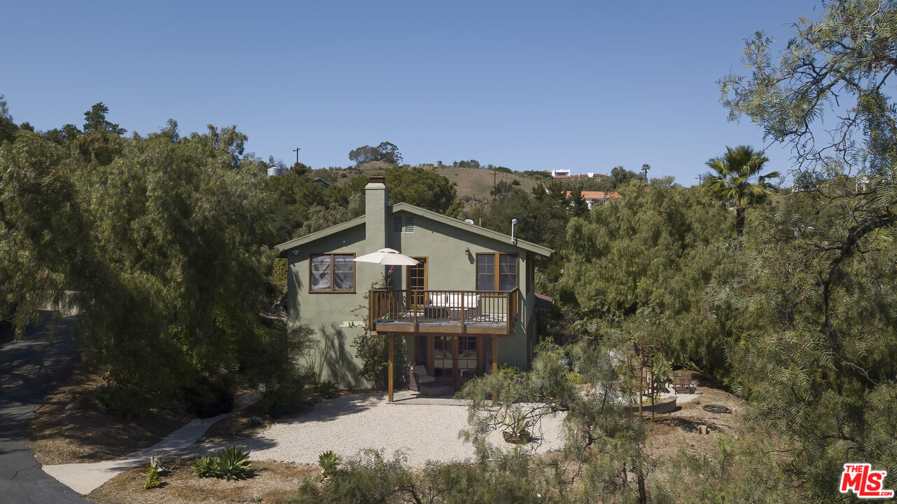 33208 Decker School Road Malibu, CA 90265 - Photo 3 of 51 a front view of a house with a yard and mountain view in back
