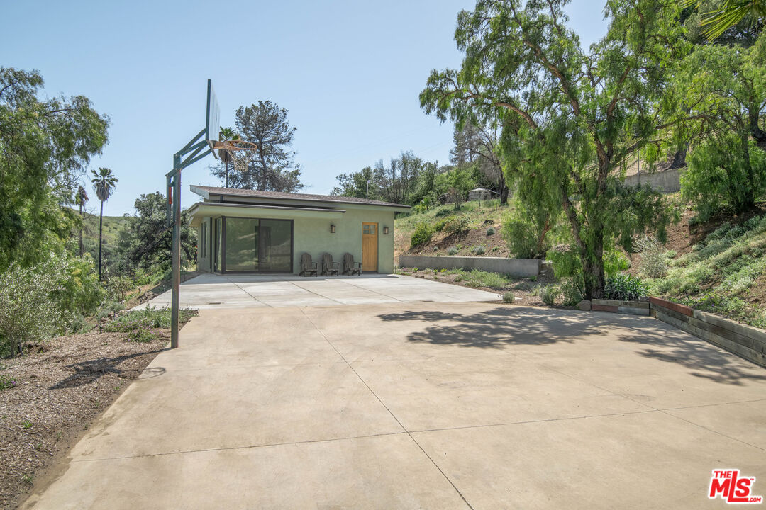 33208 Decker School Road Malibu, CA 90265 - Photo 32 of 51 a view of a house with a yard and garage