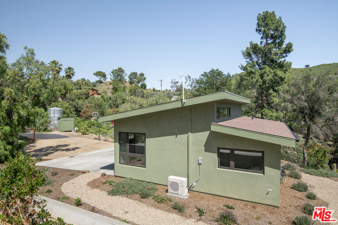 33208 Decker School Road Malibu, CA 90265 - Photo 33 of 51 a front view of a house with a yard and garage