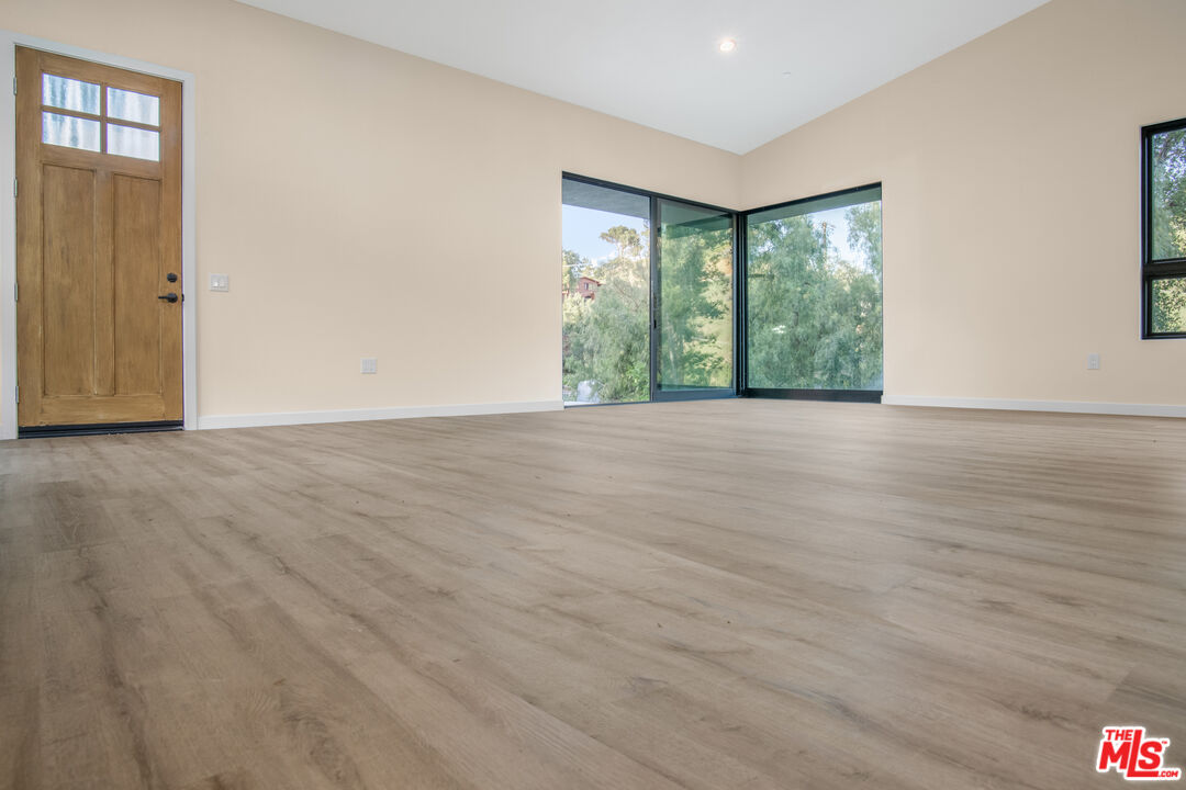 33208 Decker School Road Malibu, CA 90265 - Photo 35 of 51 a view of an empty room with wooden floor and a window