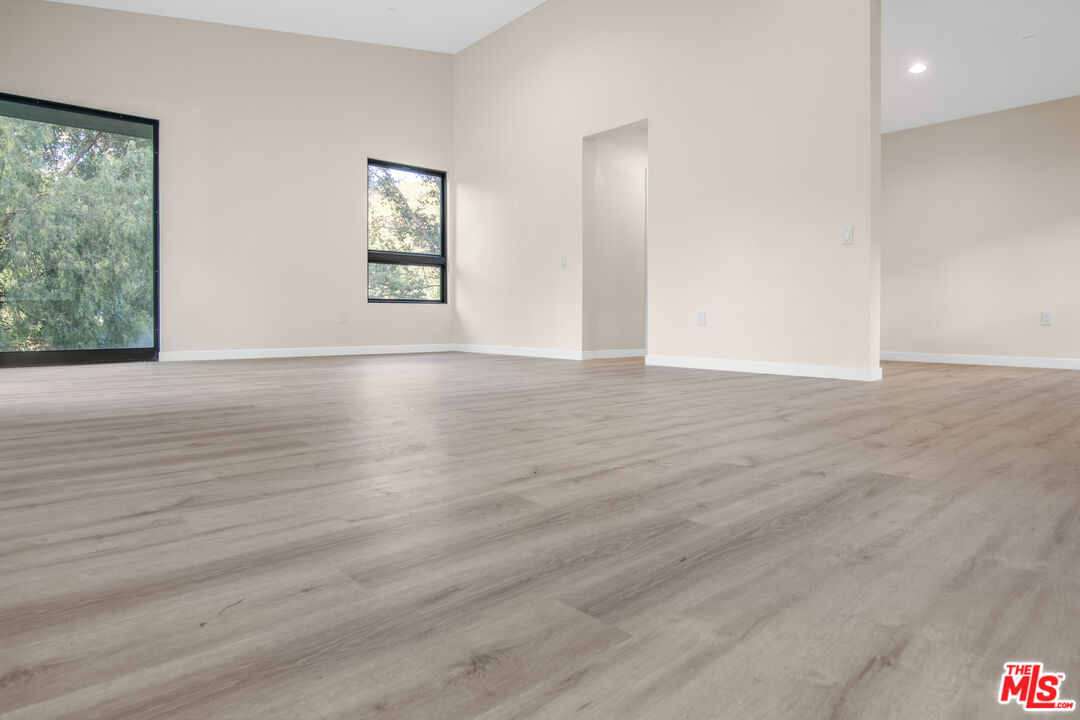 33208 Decker School Road Malibu, CA 90265 - Photo 36 of 51 a view of an empty room with wooden floor and a window