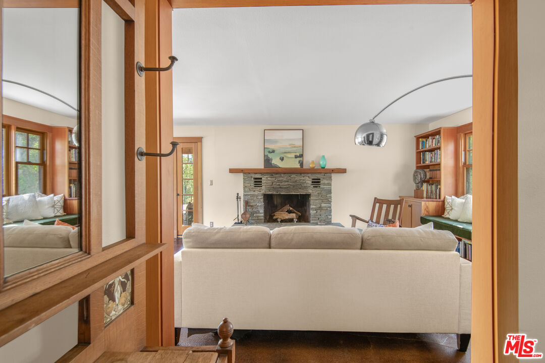 33208 Decker School Road Malibu, CA 90265 - Photo 41 of 51 a living room with furniture a large window and a fireplace