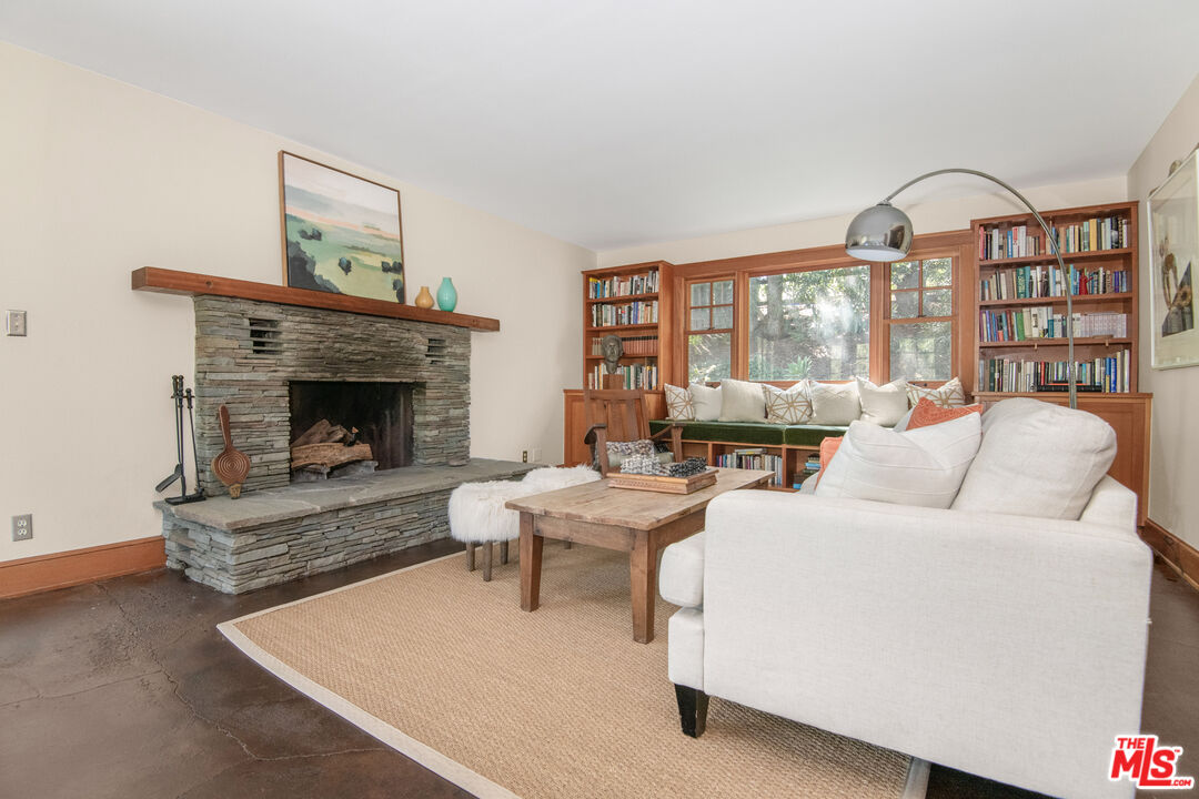 33208 Decker School Road Malibu, CA 90265 - Photo 6 of 51 a living room with furniture a fireplace and a large window
